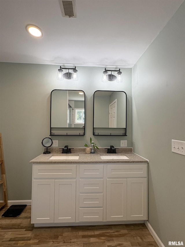 276 E Far Hills Dr, East Peoria, IL 61611 - full bathroom featuring double vanity, wood finished floors, and recessed lighting