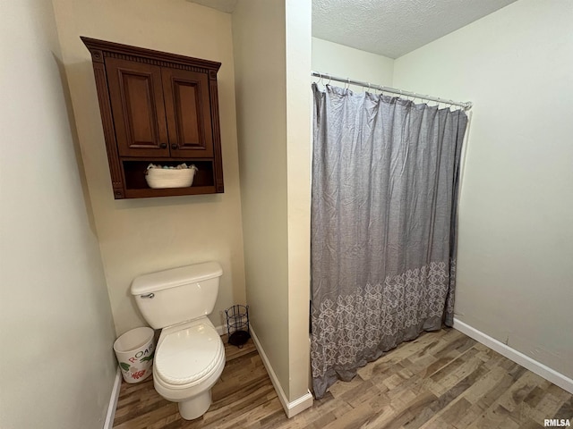 276 E Far Hills Dr, East Peoria, IL 61611 - full bath featuring wood finished floors, a shower with shower curtain, and a textured ceiling