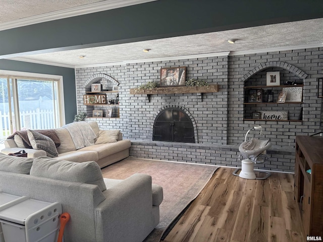 276 E Far Hills Dr, East Peoria, IL 61611 - living area featuring brick wall, a textured ceiling, wood finished floors, a brick fireplace, and crown molding
