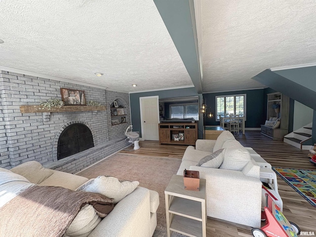 276 E Far Hills Dr, East Peoria, IL 61611 - living area with a textured ceiling, wood finished floors, ornamental molding, a fireplace, and stairs