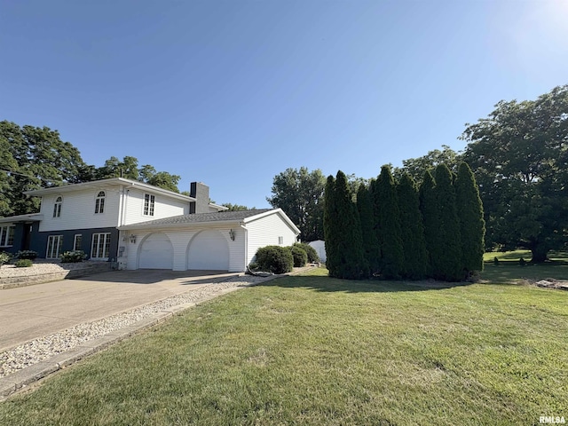 276 E Far Hills Dr, East Peoria, IL 61611 - view of side of property with a chimney, a garage, a yard, and driveway
