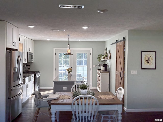 276 E Far Hills Dr, East Peoria, IL 61611 - dining room featuring a barn door, recessed lighting, and dark wood-type flooring