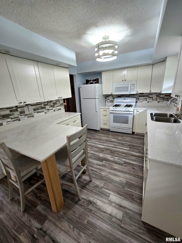 1515 Lakeview Rd N, Dahinda, IL 61428 - kitchen featuring white appliances, backsplash, a textured ceiling, dark wood-style flooring, and white cabinets