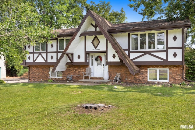 114 Julian Ave, East Peoria, IL 61611 - tudor house featuring brick siding, stucco siding, and a front lawn