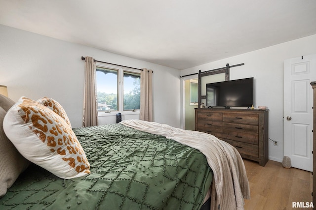 114 Julian Ave, East Peoria, IL 61611 - bedroom featuring light wood-style flooring and a barn door