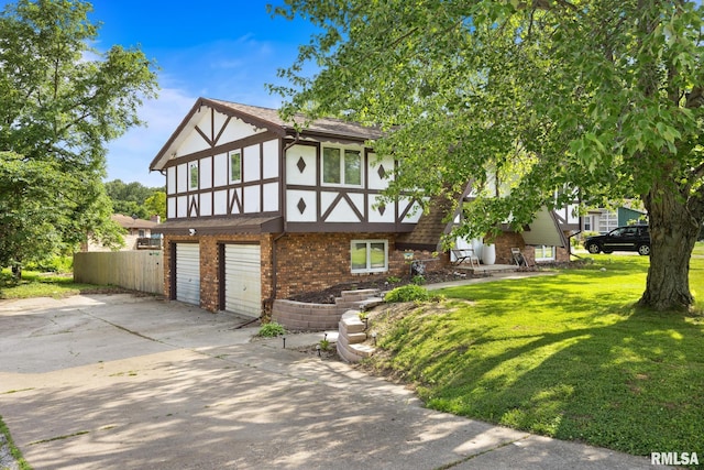 114 Julian Ave, East Peoria, IL 61611 - english style home with brick siding, stucco siding, an attached garage, a front lawn, and concrete driveway
