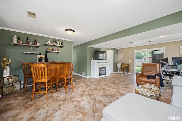 114 Julian Ave, East Peoria, IL 61611 - dining space with a dry bar, crown molding, and a glass covered fireplace