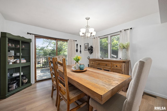 114 Julian Ave, East Peoria, IL 61611 - dining space featuring a chandelier, plenty of natural light, and light wood-style flooring
