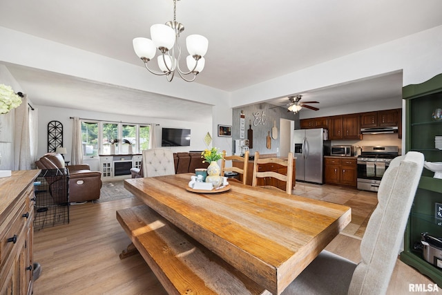 114 Julian Ave, East Peoria, IL 61611 - dining space with light wood finished floors, ceiling fan, and a chandelier