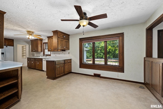 22475 N Main St, Morton, IL 61550 - kitchen with white fridge with ice dispenser, ceiling fan, dishwashing machine, light countertops, and a textured ceiling