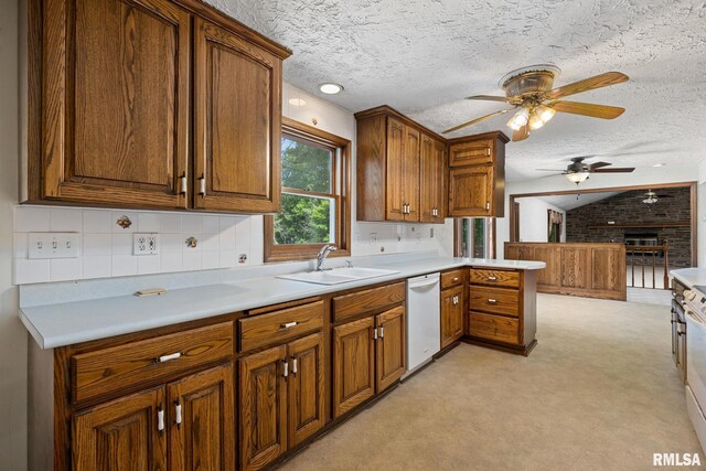 22475 N Main St, Morton, IL 61550 - kitchen with dishwasher, ceiling fan, light colored carpet, a fireplace, and light countertops