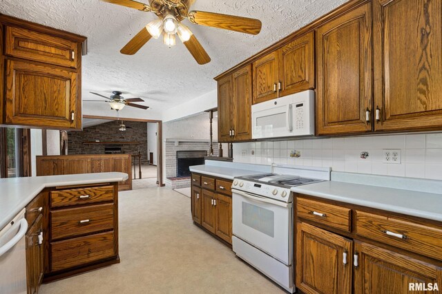 22475 N Main St, Morton, IL 61550 - kitchen featuring white appliances, ceiling fan, a brick fireplace, light countertops, and a textured ceiling