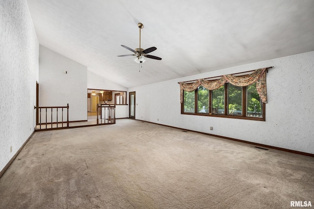 22475 N Main St, Morton, IL 61550 - unfurnished living room with ceiling fan, carpet flooring, vaulted ceiling, and a textured wall