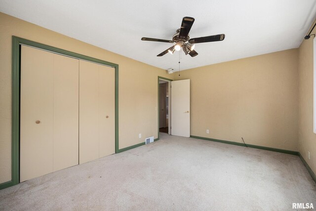 22475 N Main St, Morton, IL 61550 - unfurnished bedroom featuring light carpet, a closet, and a ceiling fan