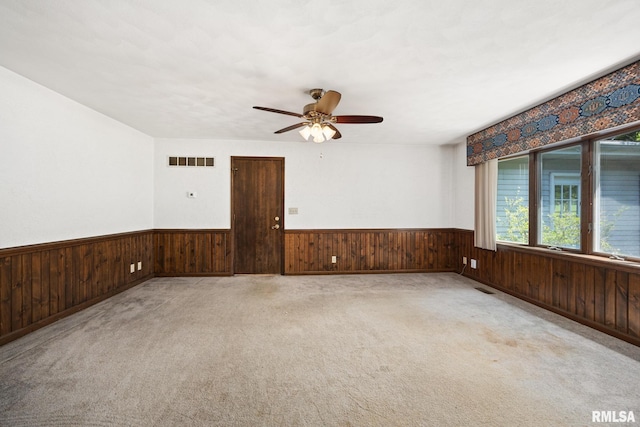 22475 N Main St, Morton, IL 61550 - unfurnished room with wainscoting, wooden walls, ceiling fan, and carpet flooring