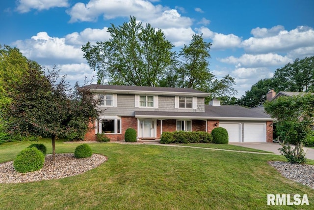 210 W Wolf Rd, Peoria, IL 61614 - traditional home featuring an attached garage, brick siding, a front lawn, and concrete driveway