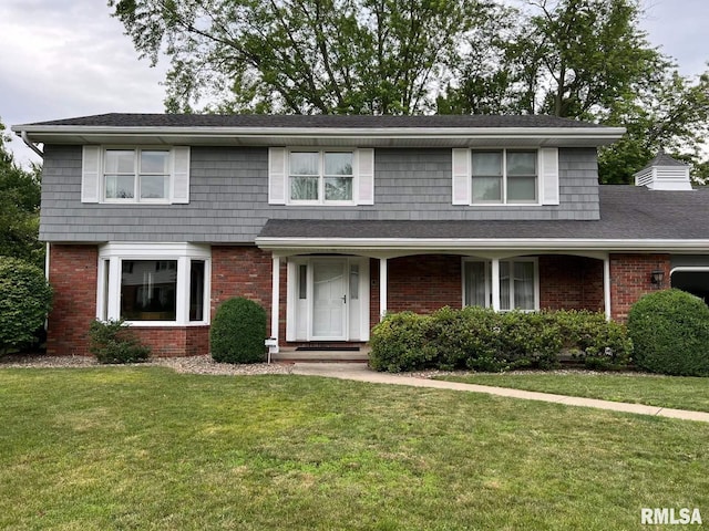 210 W Wolf Rd, Peoria, IL 61614 - traditional home featuring a front yard and brick siding