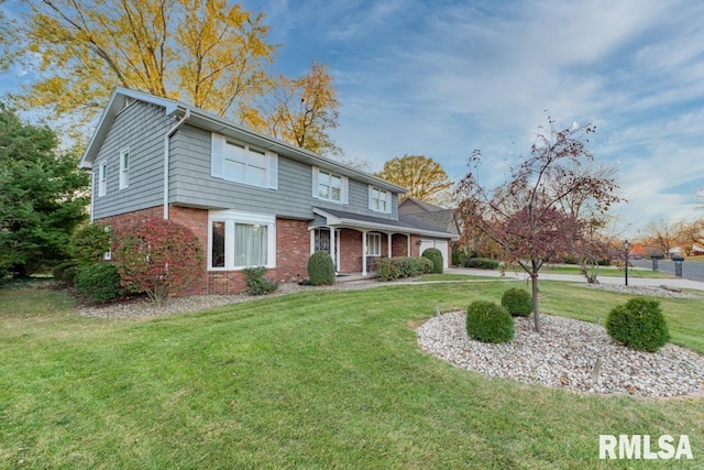 210 W Wolf Rd, Peoria, IL 61614 - traditional-style home featuring a front yard and brick siding