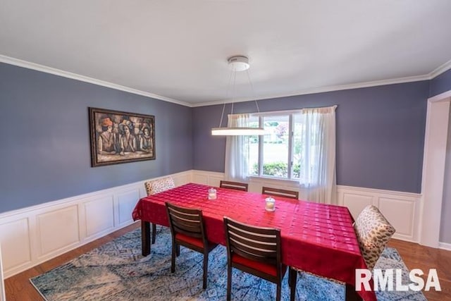 210 W Wolf Rd, Peoria, IL 61614 - dining space featuring ornamental molding, a decorative wall, wood finished floors, and wainscoting