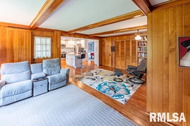 210 W Wolf Rd, Peoria, IL 61614 - living room featuring wood walls, beam ceiling, and light wood finished floors