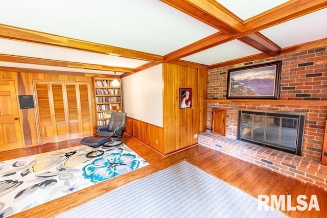 210 W Wolf Rd, Peoria, IL 61614 - living area featuring wood finished floors, wood walls, beam ceiling, and a fireplace