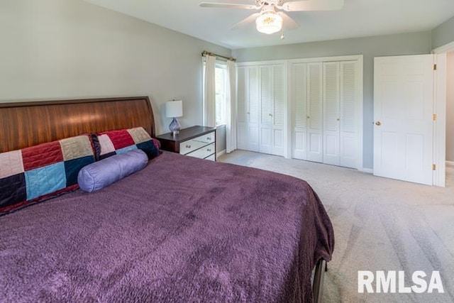210 W Wolf Rd, Peoria, IL 61614 - bedroom featuring light carpet, two closets, and a ceiling fan