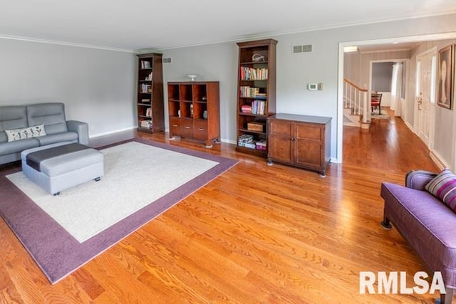 210 W Wolf Rd, Peoria, IL 61614 - living area with light wood-style flooring, ornamental molding, and stairway