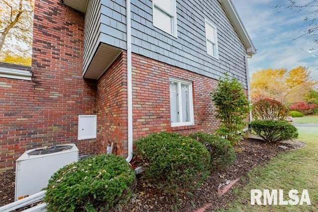 210 W Wolf Rd, Peoria, IL 61614 - view of home's exterior featuring a central air condition unit and brick siding