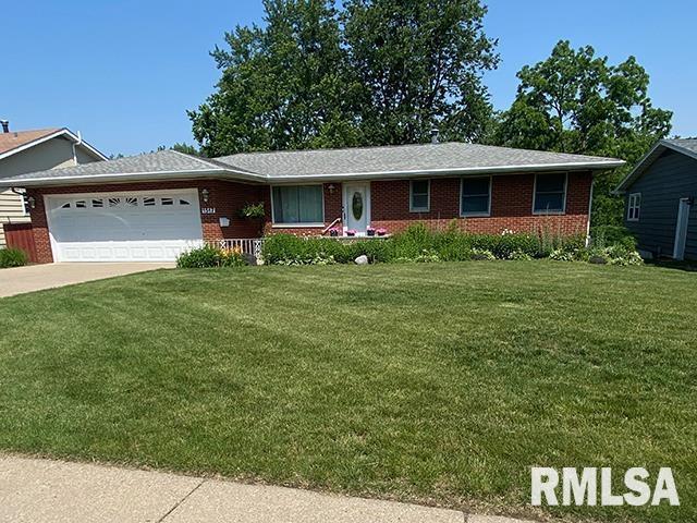 1517 W Teton Dr, Peoria, IL 61614 - single story home with a front lawn, a garage, brick siding, and driveway