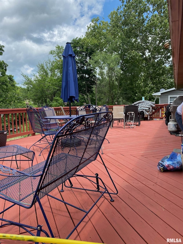 1517 W Teton Dr, Peoria, IL 61614 - wooden terrace with outdoor dining area and view of scattered trees