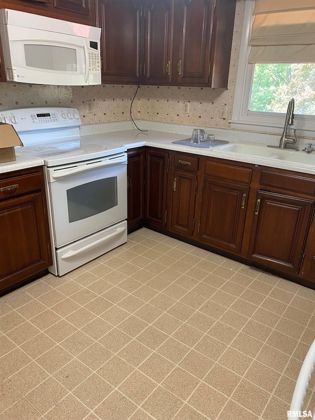 1517 W Teton Dr, Peoria, IL 61614 - kitchen with white appliances, light countertops, and dark brown cabinets