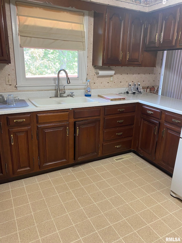 1517 W Teton Dr, Peoria, IL 61614 - kitchen featuring light countertops and dark brown cabinetry