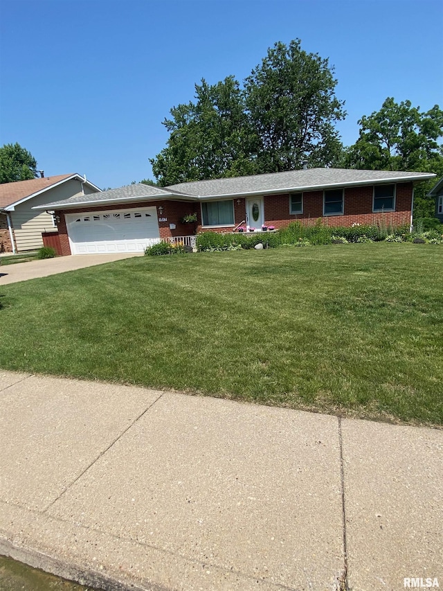 1517 W Teton Dr, Peoria, IL 61614 - ranch-style house featuring an attached garage, a front yard, brick siding, and concrete driveway