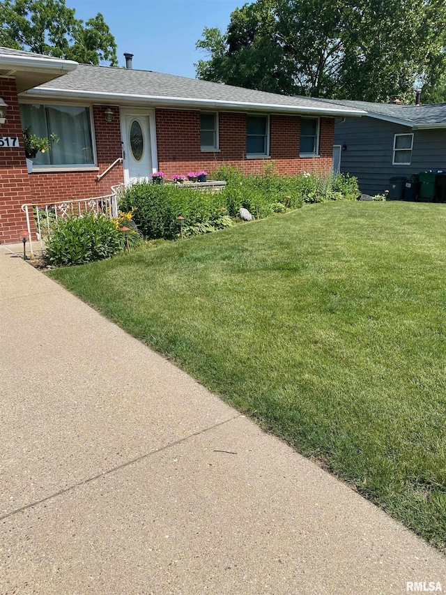 1517 W Teton Dr, Peoria, IL 61614 - single story home featuring brick siding and a front lawn