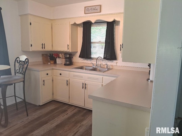 1519 S 3rd St, Pekin, IL 61554 - kitchen featuring dark wood-style flooring, light countertops, and white cabinets