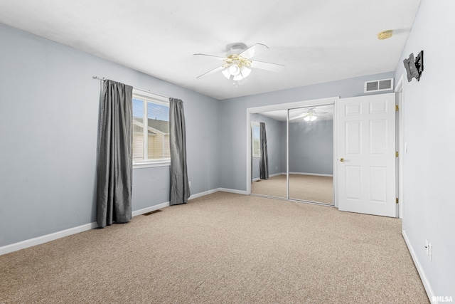 2024 S 2nd Ave, Morton, IL 61550 - unfurnished bedroom featuring light carpet, a closet, and ceiling fan