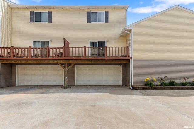 2024 S 2nd Ave, Morton, IL 61550 - rear view of property with concrete driveway, an attached garage, and a balcony