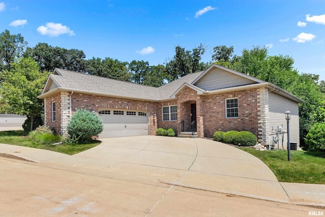 2627 W Lake Pointe Ter, Peoria, IL 61614 - view of front of property featuring a garage, brick siding, concrete driveway, and roof with shingles