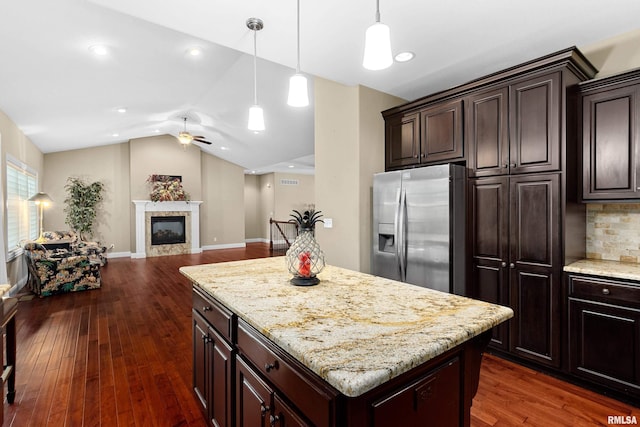 2627 W Lake Pointe Ter, Peoria, IL 61614 - kitchen featuring stainless steel fridge, a glass covered fireplace, ceiling fan, dark wood-style flooring, and vaulted ceiling