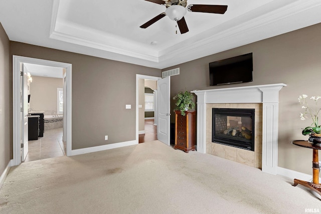 2627 W Lake Pointe Ter, Peoria, IL 61614 - unfurnished bedroom with carpet flooring, a raised ceiling, a tiled fireplace, ensuite bath, and ceiling fan