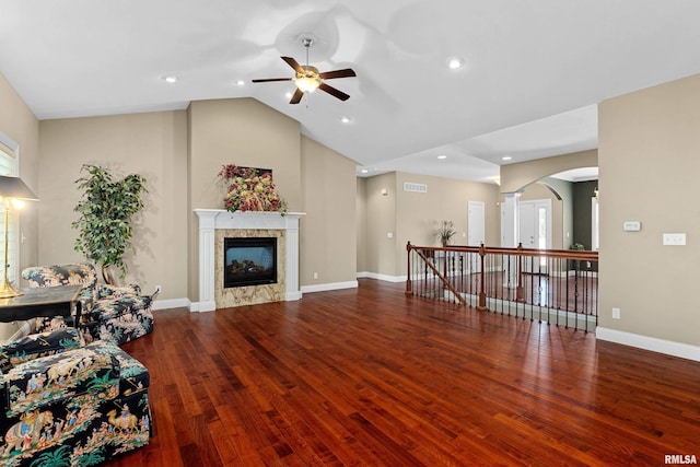 2627 W Lake Pointe Ter, Peoria, IL 61614 - living area featuring ceiling fan, arched walkways, wood finished floors, a fireplace, and lofted ceiling