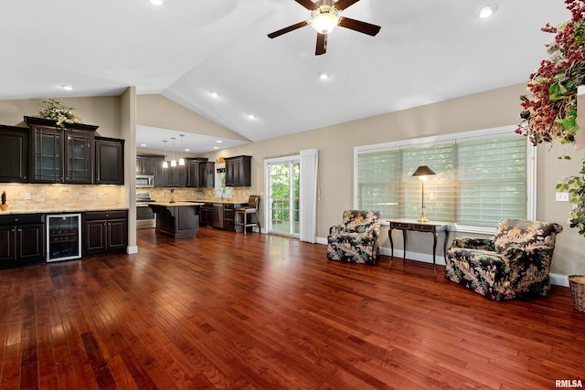2627 W Lake Pointe Ter, Peoria, IL 61614 - living area featuring beverage cooler, ceiling fan, dark wood-type flooring, lofted ceiling, and bar area
