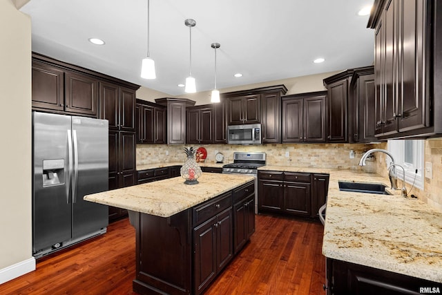 2627 W Lake Pointe Ter, Peoria, IL 61614 - kitchen with appliances with stainless steel finishes, a center island, dark wood finished floors, light stone counters, and recessed lighting