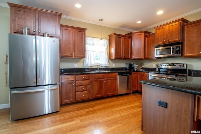 2203 W Gerald Ct, Peoria, IL 61615 - kitchen featuring appliances with stainless steel finishes, crown molding, light wood-type flooring, hanging light fixtures, and dark stone countertops