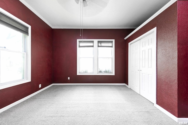 1315 N Bourland Ave, Peoria, IL 61606 - unfurnished bedroom featuring carpet flooring, ornamental molding, a closet, and a ceiling fan