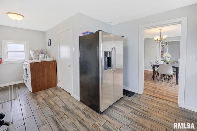 903 E Lake Ave, Peoria Heights, IL 61616 - kitchen featuring stainless steel fridge with ice dispenser, wood tiled floors, a chandelier, light countertops, and washer / clothes dryer