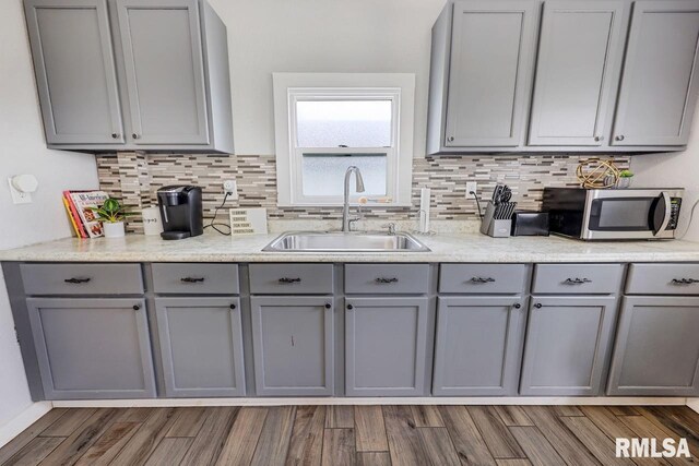 903 E Lake Ave, Peoria Heights, IL 61616 - kitchen with gray cabinets, stainless steel microwave, backsplash, and light countertops