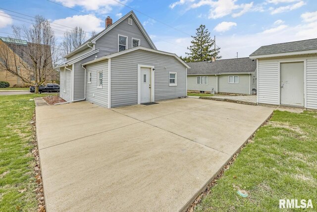 903 E Lake Ave, Peoria Heights, IL 61616 - rear view of property featuring a patio area, a chimney, and a lawn