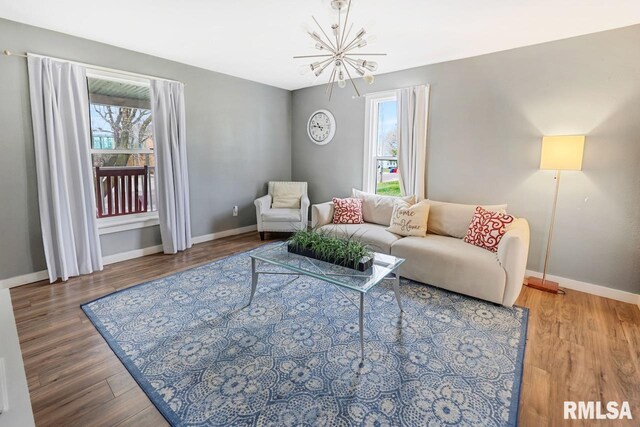 903 E Lake Ave, Peoria Heights, IL 61616 - living room with a chandelier, healthy amount of natural light, and wood finished floors