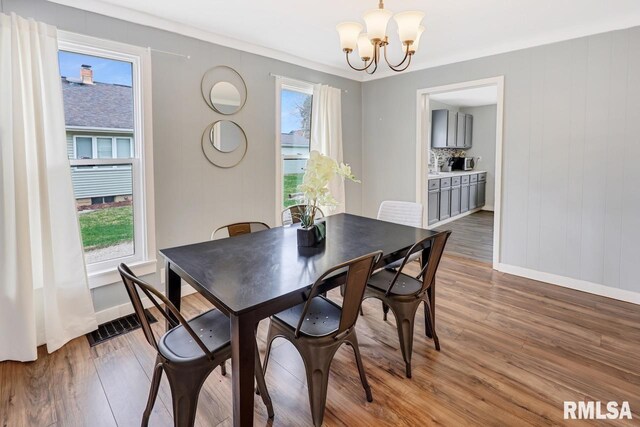 903 E Lake Ave, Peoria Heights, IL 61616 - dining room with a chandelier, healthy amount of natural light, and wood finished floors